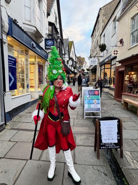 Woman in red frock coat with Christmas tree hair