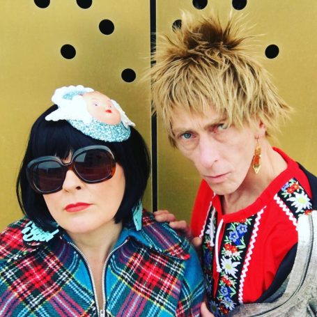 Male and female fashionistas in bright trendy clothes