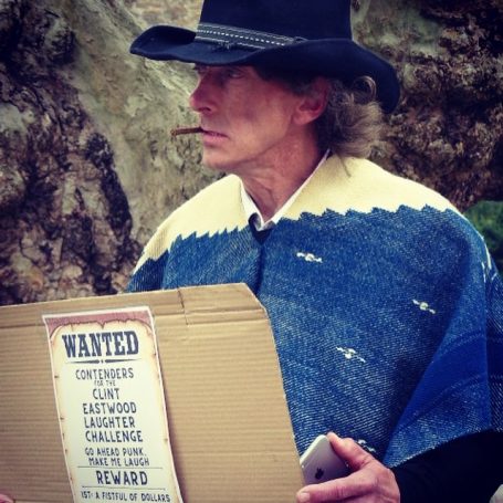 Man dressed in poncho and cowboy hat impersonates Clint Eastwood